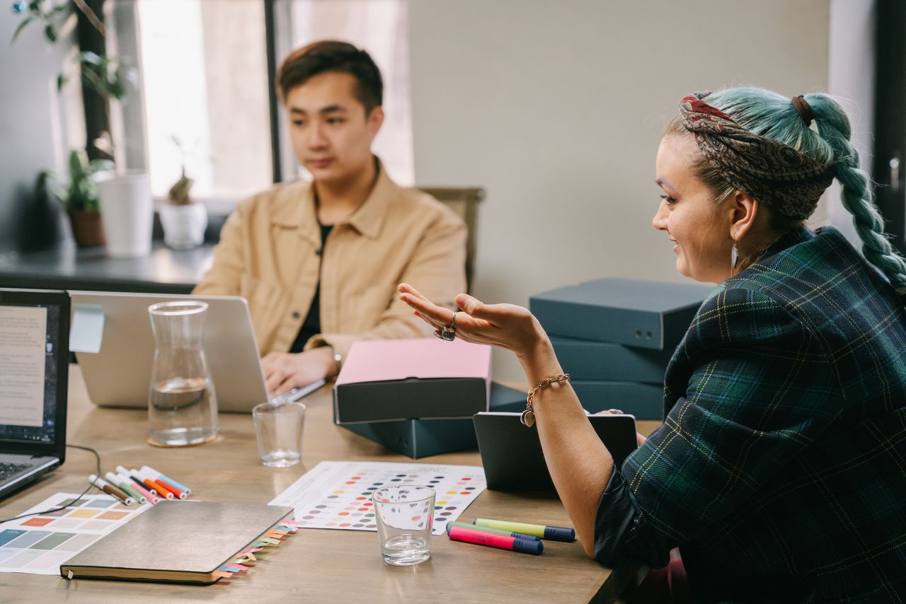 Two colleagues were involved in a productive strategy meeting at a contemporary office desk.